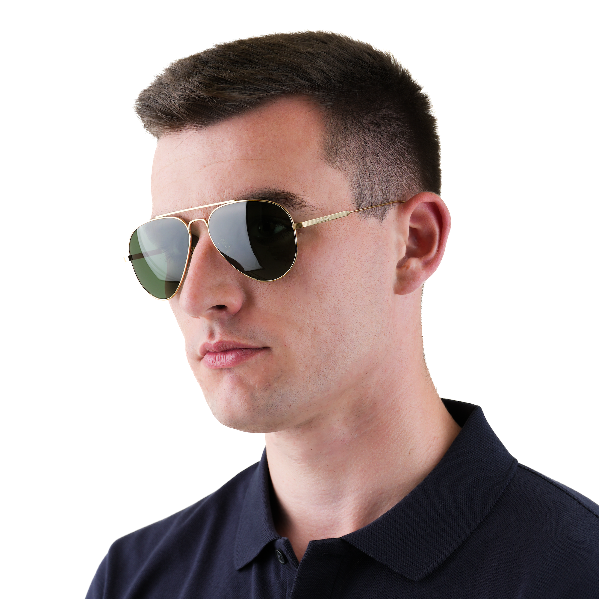 A man wearing gold-framed aviator sunglasses with green-tinted lenses and a dark navy polo shirt, shown in a close-up profile against a plain white background.