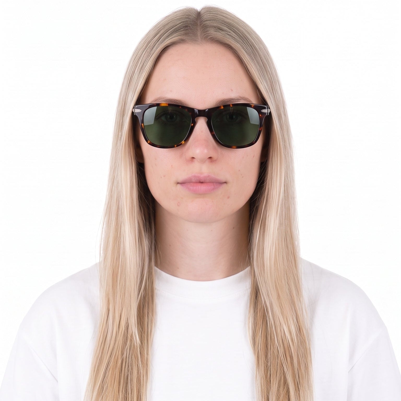 A woman with long blonde hair wearing black cat-eye sunglasses and a white t-shirt, photographed against a solid white background.
