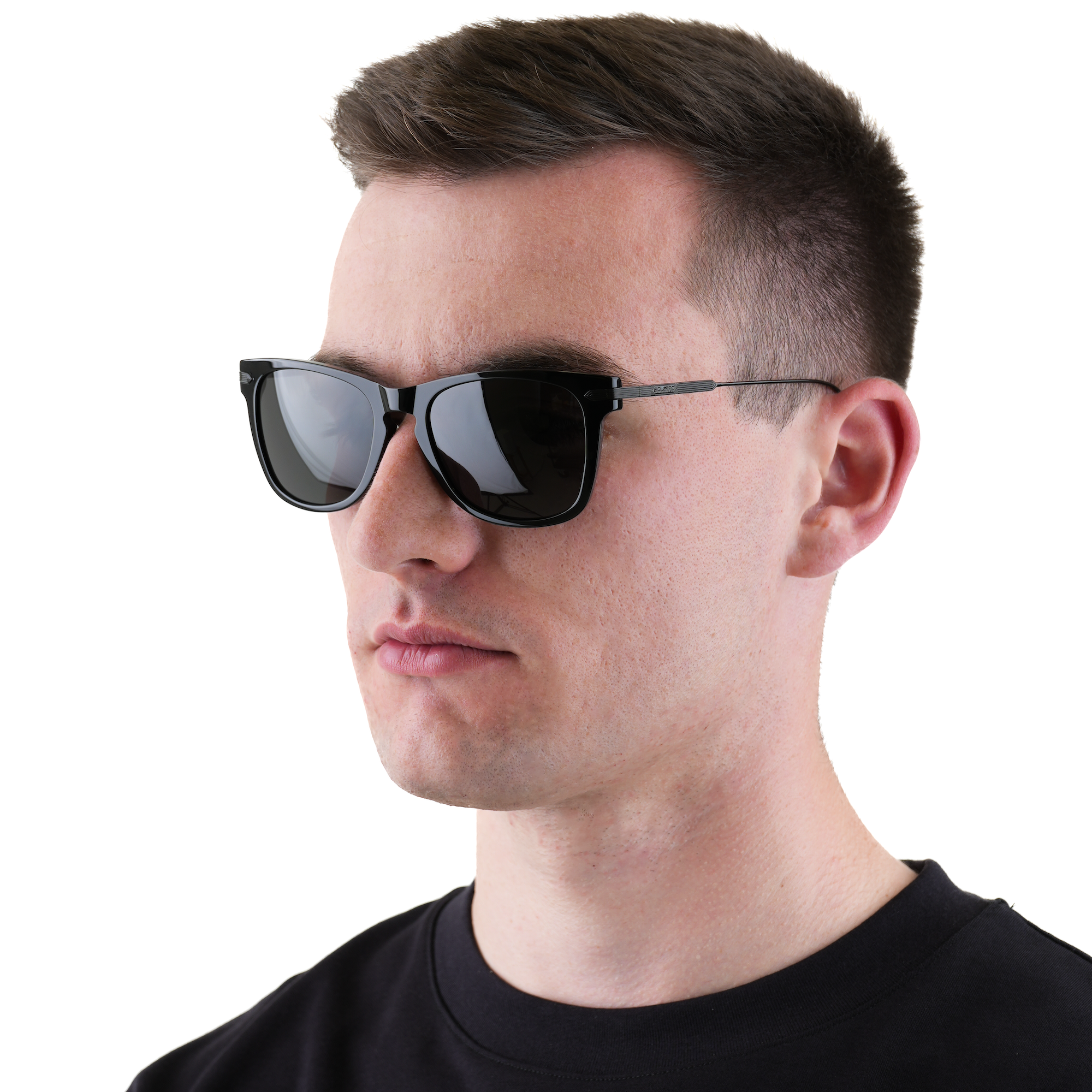 A man wearing black square sunglasses with a thin metal frame and black lenses, shown in profile against a plain white background.
