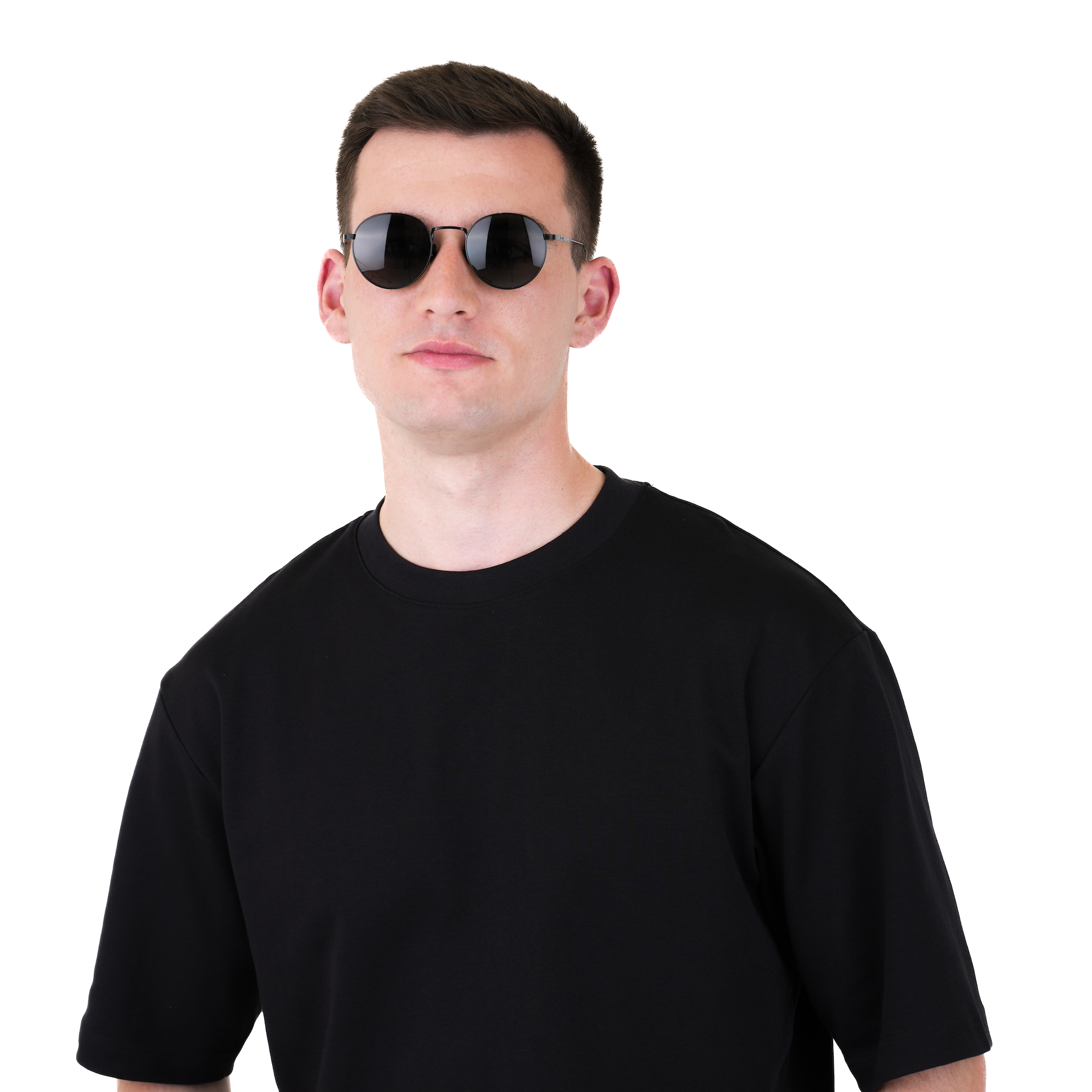A man wearing a plain black short-sleeve crewneck t-shirt and dark sunglasses, standing against a solid white background.