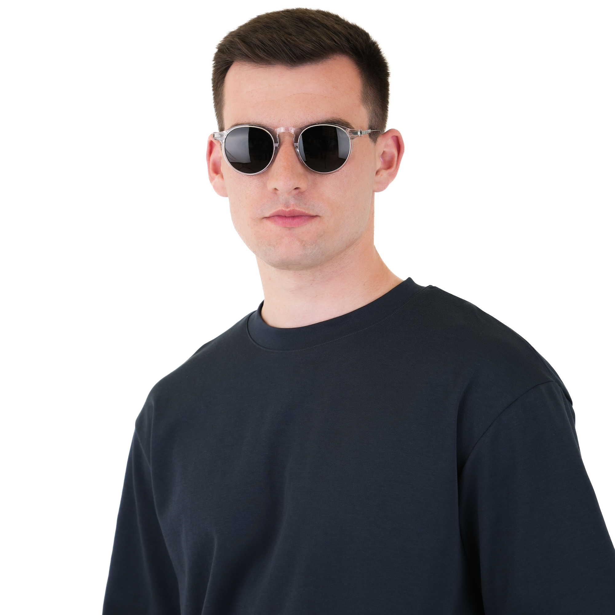 A man wearing a plain black crew-neck t-shirt and round silver-framed sunglasses, photographed against a solid white background.
