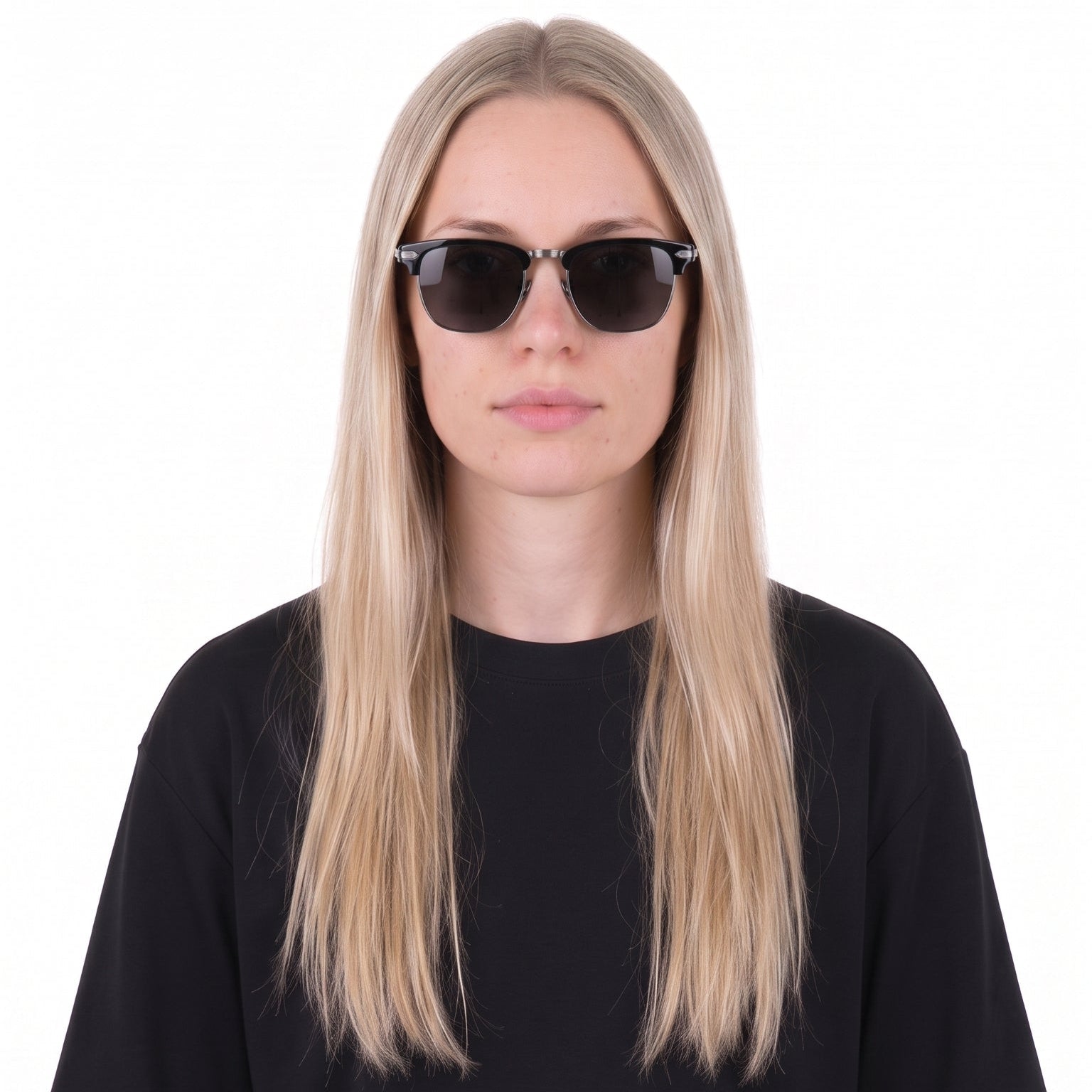 A woman with long blonde hair wearing black sunglasses and a black short-sleeve t-shirt, photographed against a solid white background.