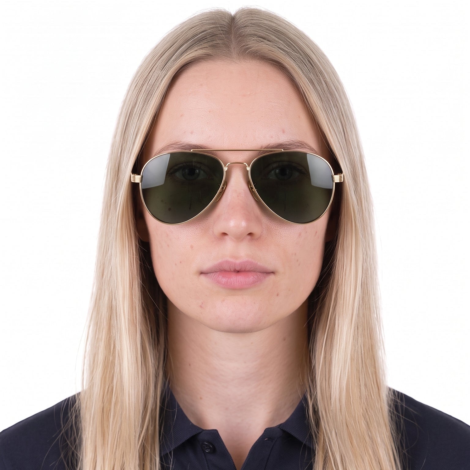 A woman with long blonde hair wearing classic aviator sunglasses with gold metal frames and dark green lenses, set against a plain white background.