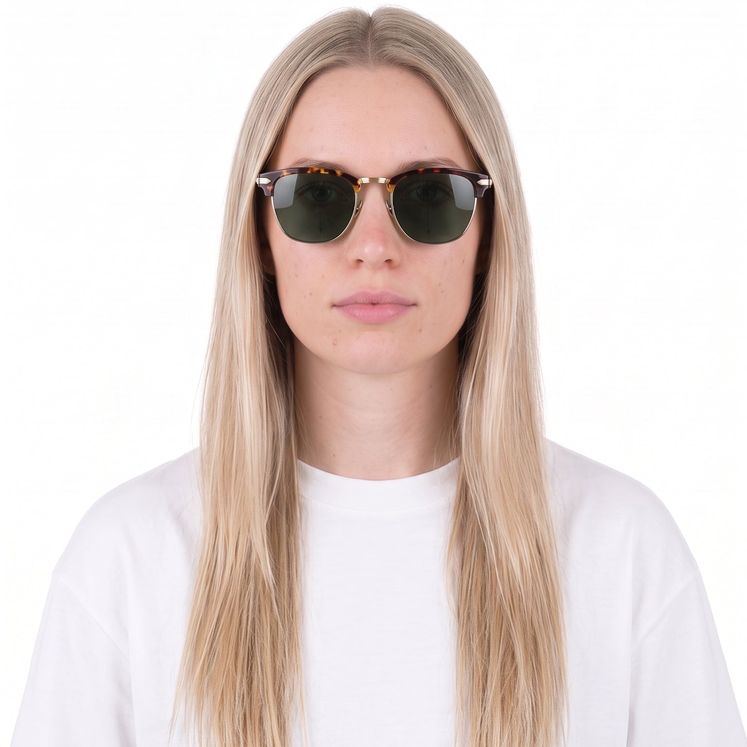 A woman with long blonde hair wearing round dark sunglasses with gold-tone frames and a plain white t-shirt, photographed against a solid white background.